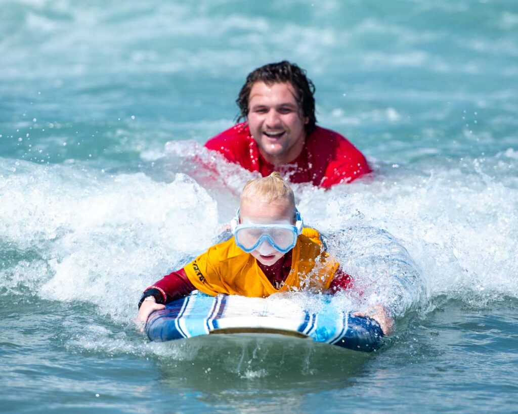 Young surfer catching a wave